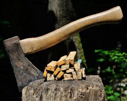 Old Axe stuck in a chopping block with splinters