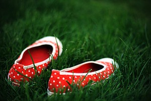 pair of red shoes in grass lawn