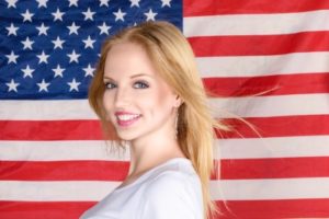 women in front of flag