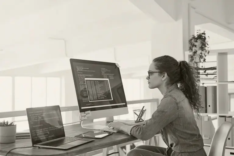 woman working on multiple screens