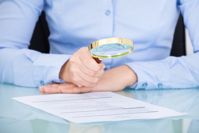 magnifying glass over document
