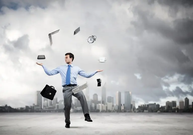 Man balancing office items cityscape