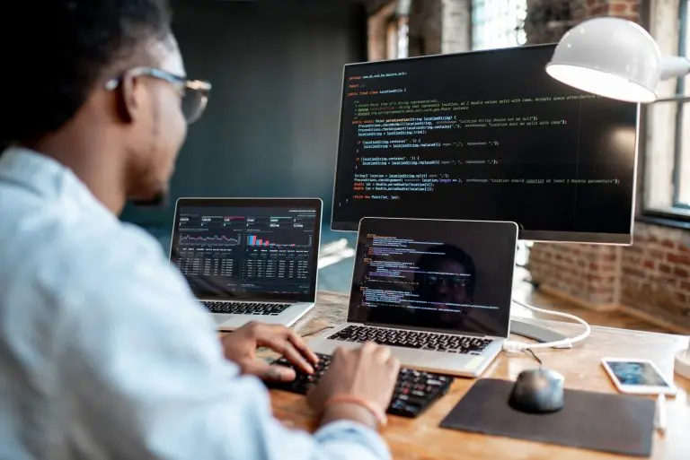programmer coding multiple screens