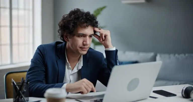 man focused on laptop