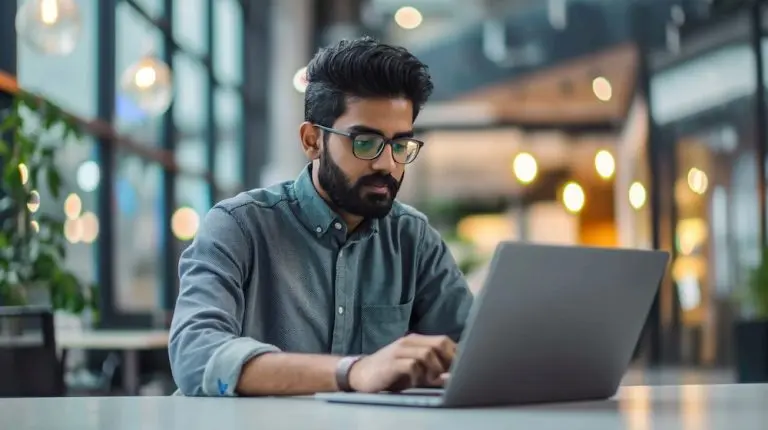man using laptop indoors