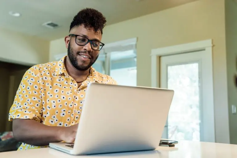 man using laptop indoors