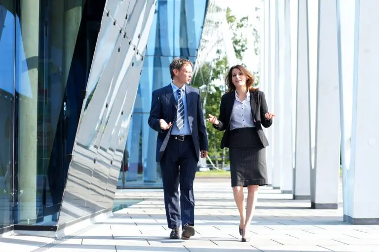 businesspeople walking modern building