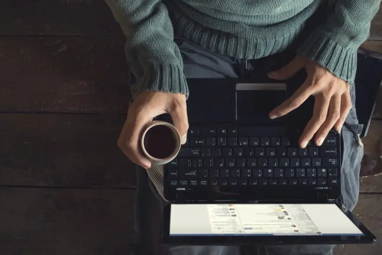 person using laptop and coffee