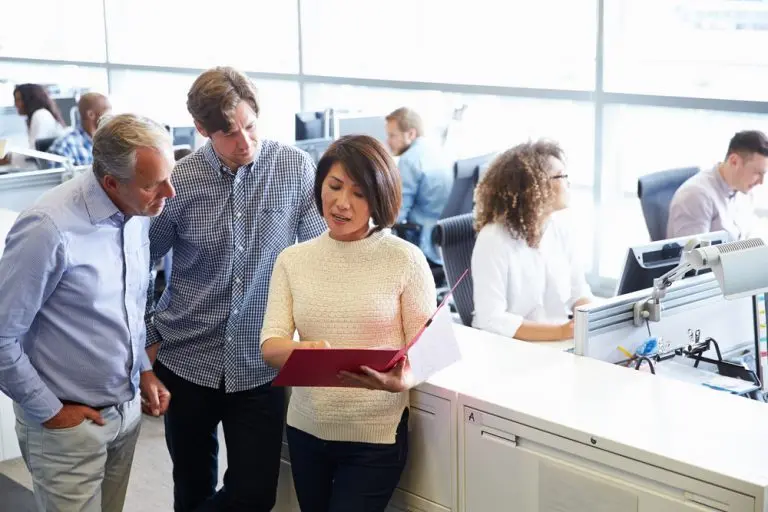 office team discussing document