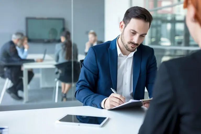 Man writing notes in office