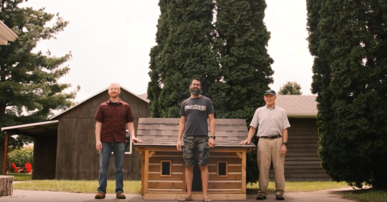 three men near small house