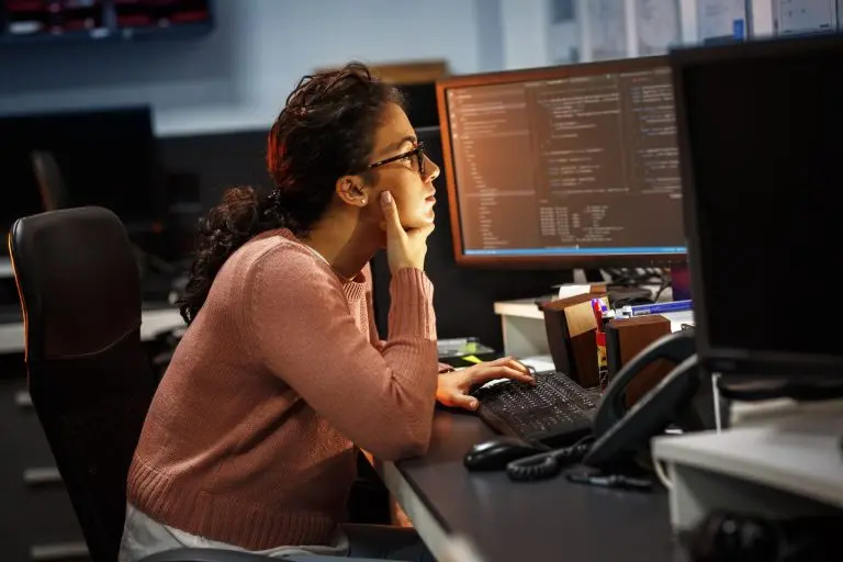 Woman analyzing code on computer