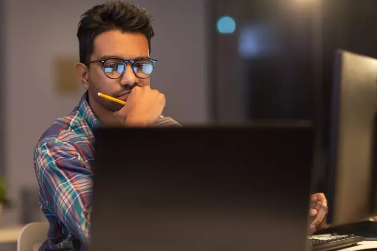 man thinking working at computer