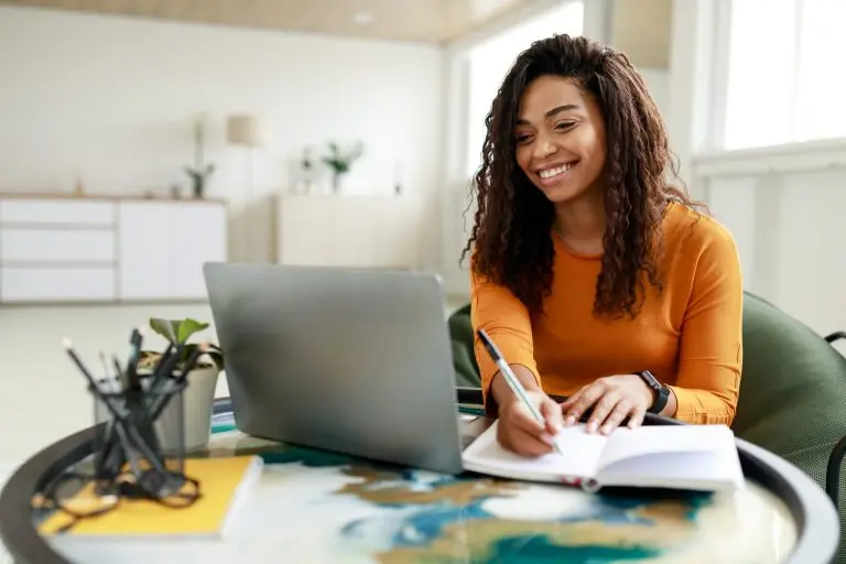 woman working on laptop smiling