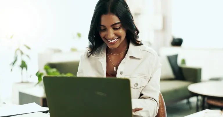 woman smiling using laptop