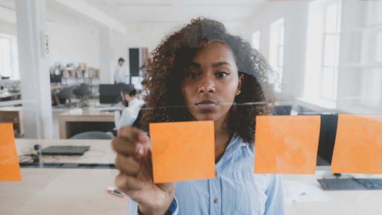 woman placing sticky notes