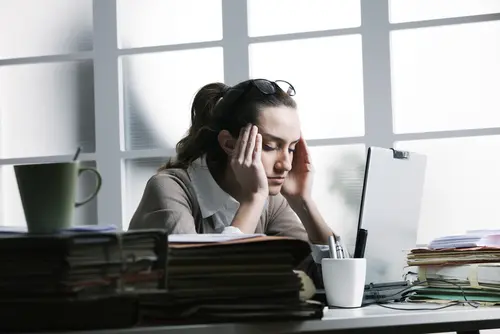 work desk with stressed woman