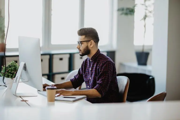 man working at computer desk