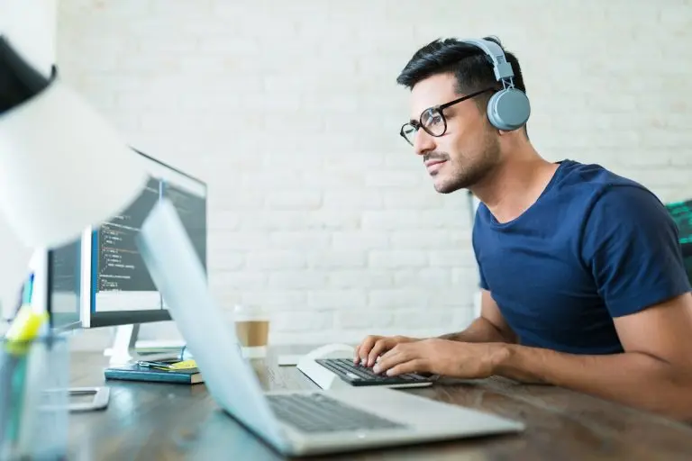 man coding with headphones