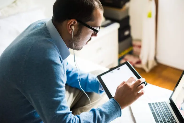 man using tablet and laptop