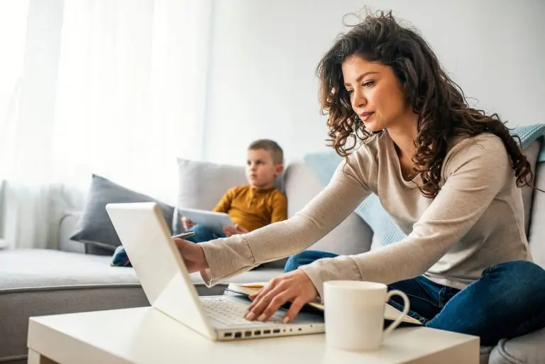 woman using laptop child nearby