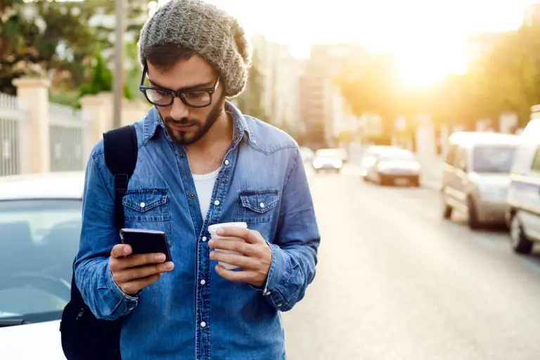 man using phone in street