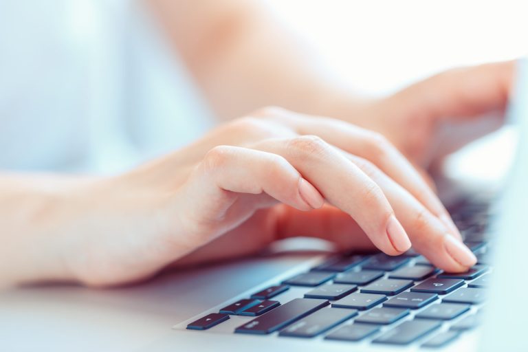hands typing on keyboard