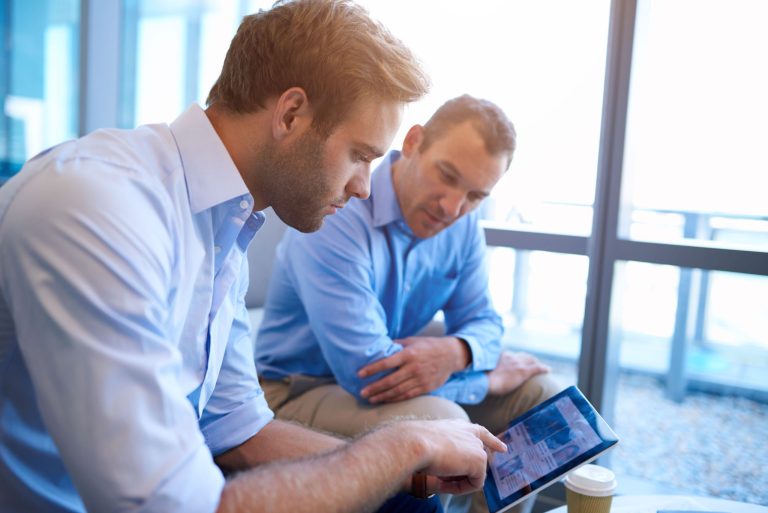 two men using tablet