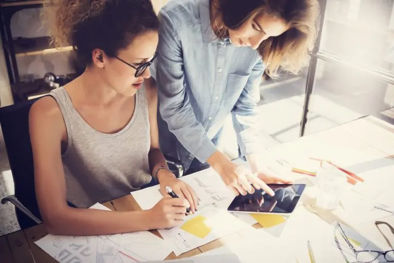 two women collaborating workstation