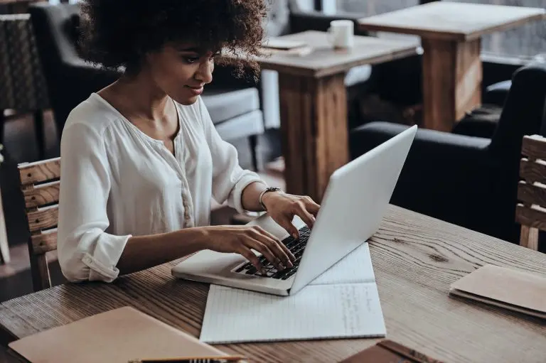 woman using laptop cafe