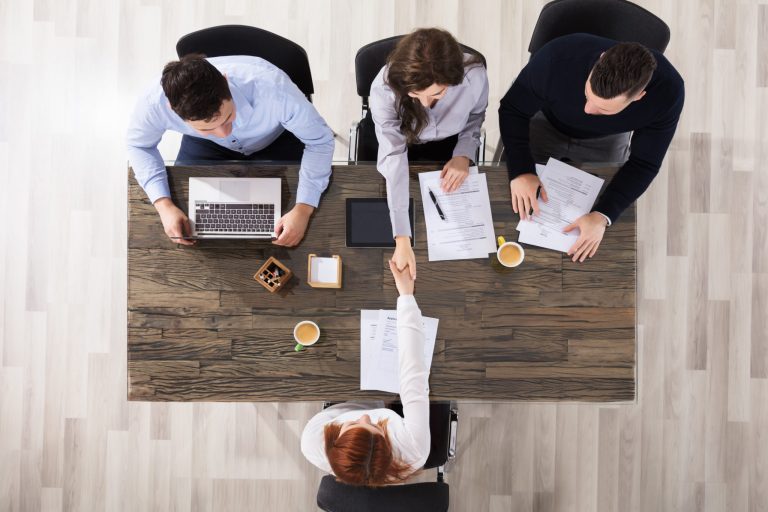 business meeting handshake overhead