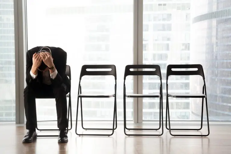man sitting head in hands